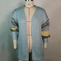 Detail view of a light blue mohair cardigan featuring colorful striped sleeves. - S / Tops / Light Blue