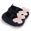 Detail view of navy baby girl walking shoes with soft sole and pink butterfly decoration - Dark Blue