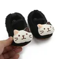 Close-up detail of black fuzzy baby walking shoes featuring a cute white cartoon cat design - Black Cat