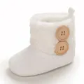 White knitted infant snow boots featuring soft faux fur collar and wooden buttons - White