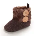 Detailed view of brown baby snow boots with fluffy faux fur and large wooden buttons - Brown