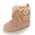 Close-up detail of cozy plush baby snow boot with knitted texture and wooden buttons - Apricot