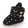 Detailed view of black baby snow boots featuring white star patterns and warm fleece lining - Insole Length 11cm / Black