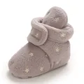 Detail of fleece baby snow boots featuring yellow embroidered stars and velcro strap - Gray
