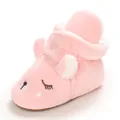 Detailed view of pink plush baby snow boots featuring a cute embroidered cartoon face - Pink
