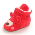 Detailed macro view of soft plush red baby winter bootie with cute cartoon bear face - Red