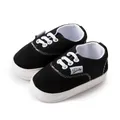 Zapatos de caminar clásicos en blanco y negro para bebés con suela de goma antideslizante - Negro