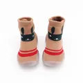 Close-up of thick terry knit baby sock shoes with cute bunny face and red stripes - Coffee Rabbit