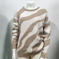 Detail showing the soft knitted texture of this beige zebra print round neck sweater. - S / Tops / Khaki