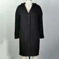 Detail view of women's black long-line hooded knitted cardigan featuring classic button closure - Black