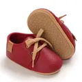 Macro view of red infant pre-walker shoes featuring a soft textured rubber sole - Inner Length 11cm / Wine Red
