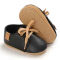 Close-up of black baby walker shoes featuring soft textured leather and non-slip rubber soles - Black
