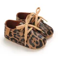 Close-up detail of leopard print baby walking shoes with soft rubber soles - Leopard Print