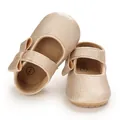 Close-up of metallic champagne baby Mary Jane shoes with soft sole and bow detail - Gold