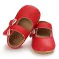 Close-up view of red baby princess shoes featuring a cute bow and soft rubber toddler sole - Insole Length 11cm / Red