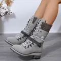 Detail view of grey mid-calf snow boots with knit patchwork and adjustable buckle strap - Gray