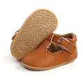 Close-up of brown infant Mary Jane shoes with scalloped edges and non-slip rubber sole - 11cm / Brown