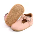 Close-up of pink baby girl princess shoes with scalloped edges and textured rubber sole. - 11cm / Pink