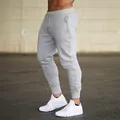 Side view of premium men's slim-fit grey joggers with adjustable drawstring waist - S / Bottoms / Light Gray