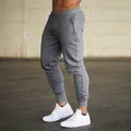 Side view detail of men's grey slim-fit joggers with drawstring and ribbed cuffs. - S / Bottoms / Dark Gray