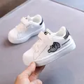 White children's shell-toe casual sneakers featuring soft soles and velcro straps - 34 / Black