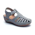 Professional side view of grey hollow-out wedge sandal featuring round toe and T-strap - Gray