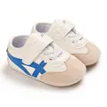 Close-up detail of white baby walking shoes featuring soft soles and blue stripe design - Blue (Full PU)