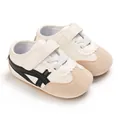 Detailed view of stylish white baby walking shoes featuring black stripes and soft soles - Black (Full PU)