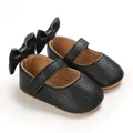 Detailaufnahme schwarzer Baby-Prinzessin-Lauflernschuhe mit großer Schleife an der Ferse - Schwarz