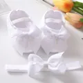 Detail view of white baby lace shoes and matching bow headband set for infants. - White And Headband