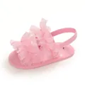 Close-up of pink baby sandals with ruffle lace detailing and soft sole - Pink