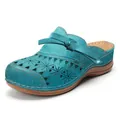 Close-up detail of teal laser-cut leather mules with decorative bow and brown platform sole - 35 / Lake Blue
