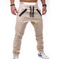 Close-up of men's khaki biker joggers with double zipper pockets and pleated details. - M / Bottoms / Beige