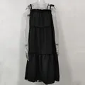 Detail view of the tiered design and ruffled neckline on this black summer sundress. - Black