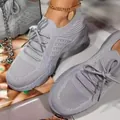 Detailed view of grey fly-knit breathable mesh sneakers for women's casual wear - Gray