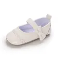 Detailed macro view of white baby girl princess walker shoe featuring a cute bow - White