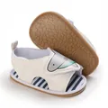 Detailed view of white baby shark sandals with soft non-slip sole and striped insole - White