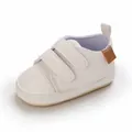 Detailed view of white soft-soled baby walking shoes with hook-and-loop straps - White