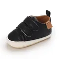Close-up of black pebbled faux leather baby walking shoe with double velcro straps - Black