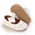 Detailed view of baby girl white princess shoes featuring soft anti-slip rubber soles - White