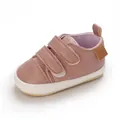 Close-up of pink faux leather baby walker shoe featuring dual velcro straps and soft sole - Pink