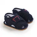 Detail view of navy blue polka dot baby walking sandals with soft rubber anti-slip soles - Dark Blue