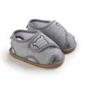 Detail of grey baby sandals featuring a cute bear silhouette and soft rubber soles - Gray