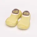 Detailed macro view of breathable yellow knit baby sock shoes with a flexible soft rubber sole - Turmeric