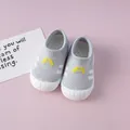 Close-up of breathable grey knit baby walking shoes with soft white rubber soles. - Gray