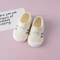 Detail view of breathable flyknit baby walking shoes with soft white soles - Yellow