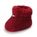 Gros plan d'un chausson de bébé rouge en peluche pour l'hiver, texture très douce - Rouge