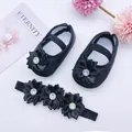 Detailed view of black infant princess shoes and matching floral headband set - Black