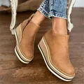 Close-up of brown suede wedge ankle boots with thick striped platform and side zipper. - 35 / Tan