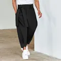 Detailed view of men's black tie-waist cropped casual pants featuring a relaxed fit - S / Bottoms / Black